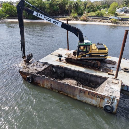 Aerial view of a coastal area with clear blue waters and sandy beaches, captured by a drone.